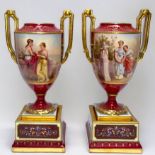 WITHDRAWN: A pair of 19th century Vienna Porcelain twin-handled pedestal vases, rouge grounds gilded