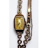 A ladies 9ct gold cased wristwatch, the rectangular dial with Arabic numerals denoting hours, on 9ct