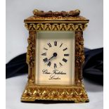 An ornately decorated brass-cased carriage clock by Charles Frodsham & Co, London, cast caryatid