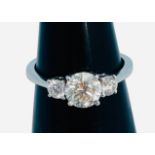 An 18ct white gold ring, set with a central round brilliant cut diamond, estimated weight 1.00cts,