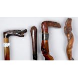 A Vine-twisted wooden walking stick with metel-capped handle and metal coller engraved 'W. Marchant,
