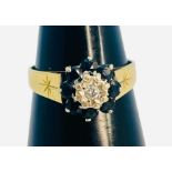 An 18ct yellow gold dress ring, illusion set with a small round diamond to the centre, and eight