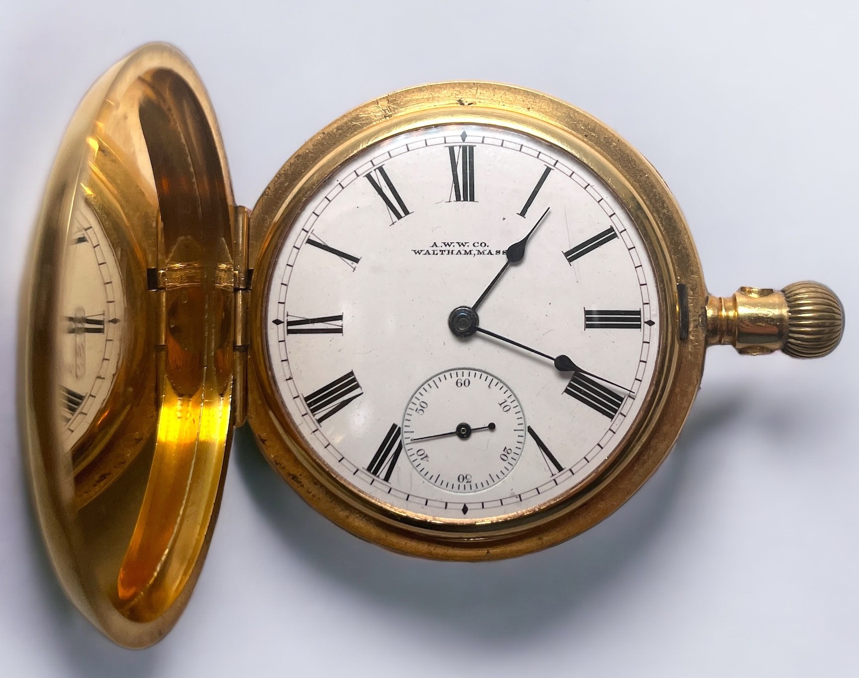 An 18ct gold full-hunter pocket watch by AWW. Co Waltham, the white enamel dial with Roman