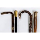 Four walking canes comprising an Edwardian Blackthorn walking cane with 9ct gold-capped hook handle,