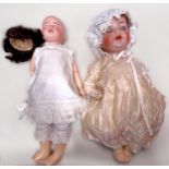 An early 20th century German Simon & Halbig bisque socket head doll, brown glass sleeping eyes, also