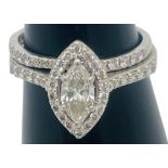 A platinum and diamond halo ring, set with a marquise cut diamond to the centre, surrounded by 20