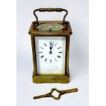 A 19th century French brass repeater carriage clock, the white enamel dial with Roman numerals