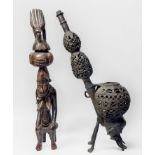 A cast copper alloy Cameroon ceremonial pipe, modelled with a stylised boars head, holding the bowl,