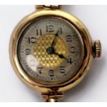 A vintage ladies 9ct gold wristwatch, the silvered chapter ring with Arabic numerals denoting hours,