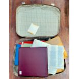 A suitcase containing GB stamps, including mounted mint stamps in stock books, some mounted used,