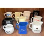 Ten various ceramc water jugs including Glen Adam, Brown Label and John Begg (section 35)