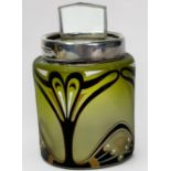 A silver-mounted cylindrical green-tinted glass dressing table jar with Art Nouveau enamel and
