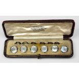 A set of six 9ct white gold, mother-of-pearl and seed pearl dress buttons, of octagonal form with