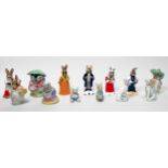 Five Royal Doulton Bunnykins figures, four Beatrix Potter figures and a pair of seated Cheetah's