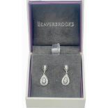 A pair of 9ct white gold drop earrings, each main drop, set with two round brilliant cut diamonds to