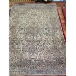 A Persian hand-knotted wool Nain carpet, with central medallion to an ivory ground, worked with