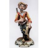 A Capodimonte figure of a huntsman with rabbit walking by a tree stump, with factory marks to
