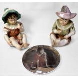 A pair of bisque porcelain piano babies, 32cm tall, together with a Royal Doulton plate ‘Good