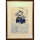 A 19th century Japanese woodblock print of a Samurai slashing a stack of paper, printed in blue