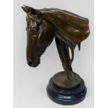 A cast and patinated bronze bust of a horse head, mounted on circular marble plinth, 31cm high