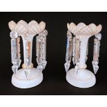 A pair of white frosted glass lustres with gilded decoration, crenellated circular tops raised on