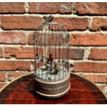 A 20th century singing bird automaton modelled as a birdcage housing two birds, one red and one