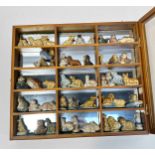 A collection of assorted Wade whimsies animal figures, in small compartmented display case, together