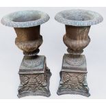 A pair of 19th century cast iron pedestal campagna urns, 77cm high