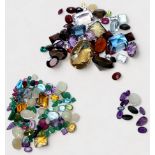 A quantity of assorted loose gemstones including amethyst, emerald, smoky quartz, aquamarine, opals,