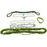 A peridot bead six strand necklace, with white metal clasp, and peridot bead bracelet from Shipton &