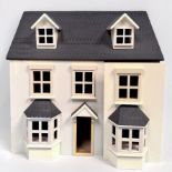 Two modern wooden dolls houses, including a Pintoy example with stained wood finish and red roof,