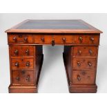 A Victorian walnut kneehole pedestal desk, oak top and black leather scribe, central frieze drawer