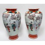 A pair of Japanese porcelain vases, of ovoid form painted with Geisha girls in a blossom landscape