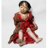 An early 20th Century Japanese doll, boy, composite head, arms, torso and legs with cloth upper leg,