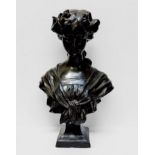 A cast and patinated bronze bust of a young lady wearing a laurel wreath in her hair, shawl tied