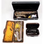 Three cased woodwind instruments, comprising a Windsor brass tenor saxophone, pearlised keys, in