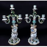 A pair of 19th century German porcelain figural three-branch candelabra, of rustic form modelled