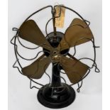 A vintage Revo Motor table fan, with a decorative bent wire cage, serial no. 48175, approx 42cm tall