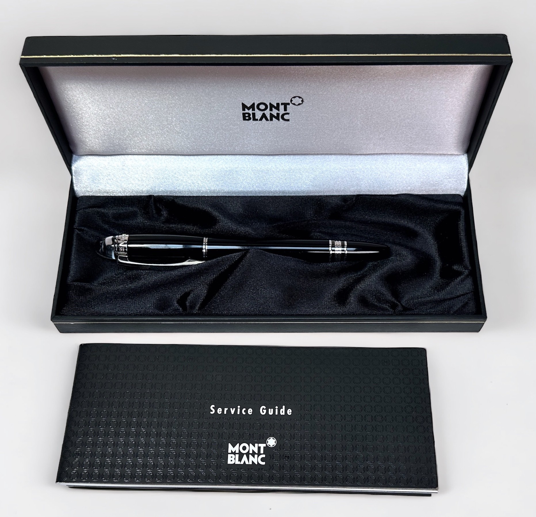 A Montblanc Starwalker black resin rollerball pen, with screw cap and white metal fittings, with