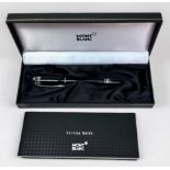 A Montblanc Starwalker black resin rollerball pen, with screw cap and white metal fittings, with