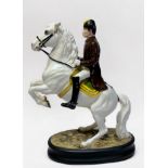 A Beswick pottery Lipizzaner horse and rider ‘2467’, raised on oval base, second version, printed