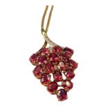 A 9ct yellow gold pendant and chain, set with 17 x red faceted stones, and 3 x small diamonds, in