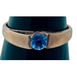 A 9ct rose gold dress ring, tension set with a round faceted Tanzanite, weight of stone 0.34cts,