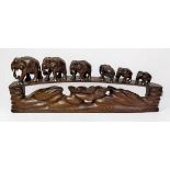 A carved wooden elephant group, a composition elephant group and bear group, together with a