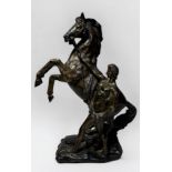 A bronze figure of a Marly horse, raised on naturalistic base, unsigned, 38.5cm tall