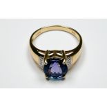 An 18ct yellow gold tanzanite and diamond dress ring, set with a round faceted tanzanite to the