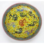 A Chinese porcelain charger, incised and decorated in polychrome enamels, with nine dragons,