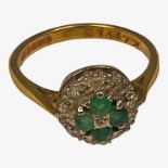 An 18ct yellow gold emerald and diamond cluster dress ring, weighs 4.0 grams.