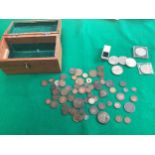A wooden box containing various mainly British coins but with a few foreign – in mixed condition