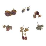 Six pairs of pierced earrings, set with various gemstones, including ruby, amethyst, and aquamarine,